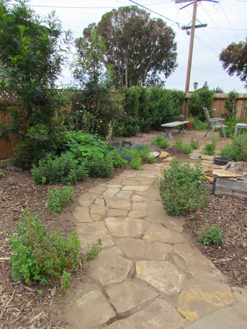 Adding a flagstone walkway directed one into the heart of the garden